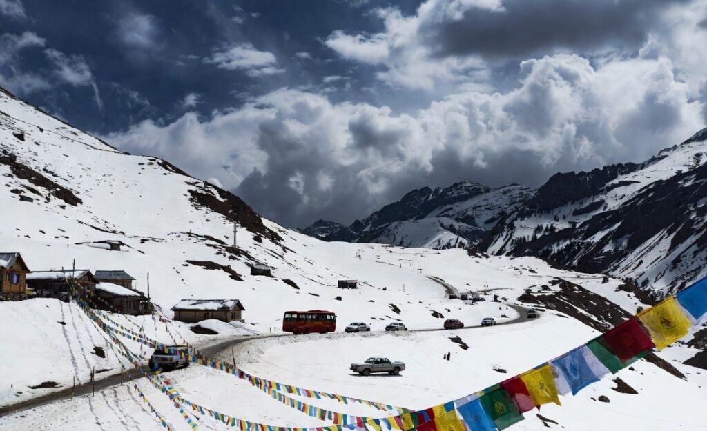Epic snow-capped Rohtang Pass near Manali with prayer flags and Himalayan grandeur – a must-see highlight in every Manali travel review 2026.