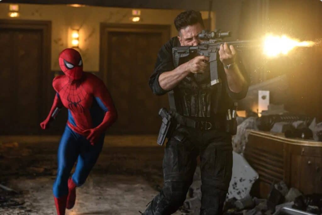 Spider-Man and the Punisher share a chaotic indoor shootout in Brand New Day. Alt text: Tom Holland as Spider-Man running left while Jon Bernthal as the Punisher fires a rifle to the right inside a damaged interior in Spider-Man Brand New Day 2026.