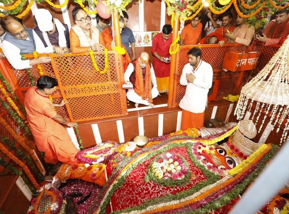 Ornately decorated Bade Hanuman Ji lying statue in Prayagraj temple, a key religious site for visitors.